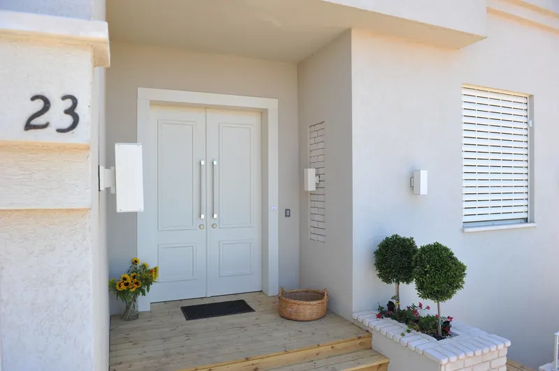 White double front doors at a house entrance