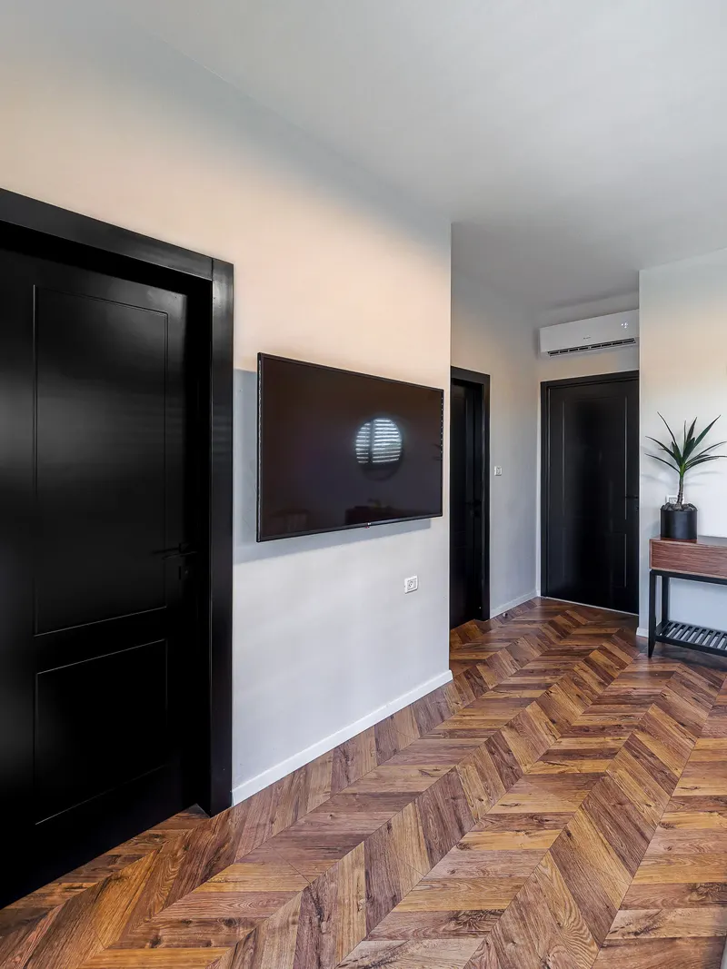 Black interior doors along a hallway