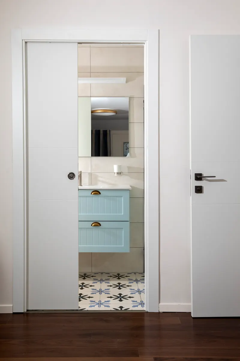White pocket door opening to a bathroom