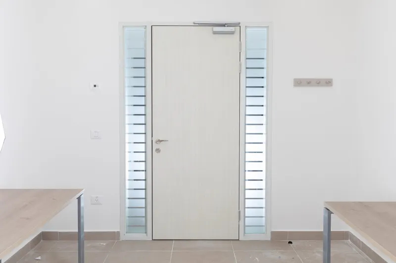 White door with glass side panels in an office